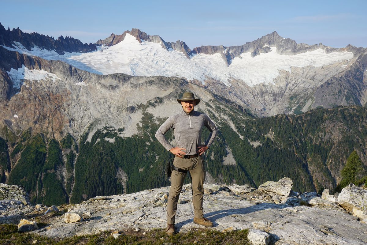 Boone standing above a glaciated basin deep in the mountains