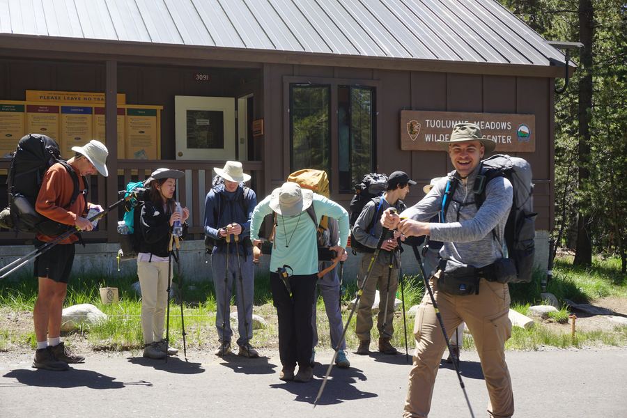 A trip crew shouldering packs at the trailhead