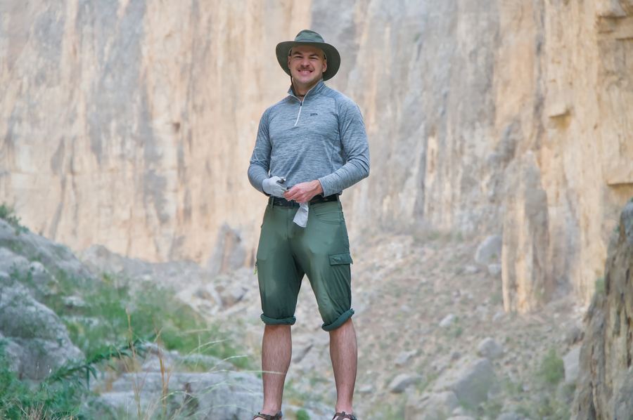 Boone below sheer canyon walls